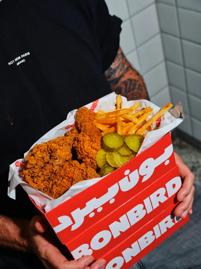 A Bonbird box of fried chicken tenders, spicy fries and pickles