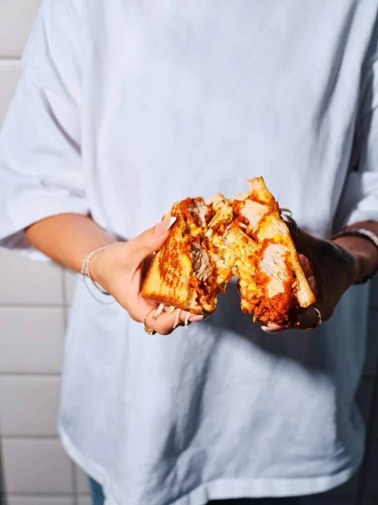 A Bonbird chicken melt sandwich pulled apart